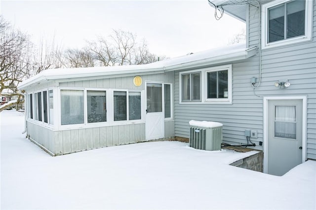 snow covered property featuring central air condition unit