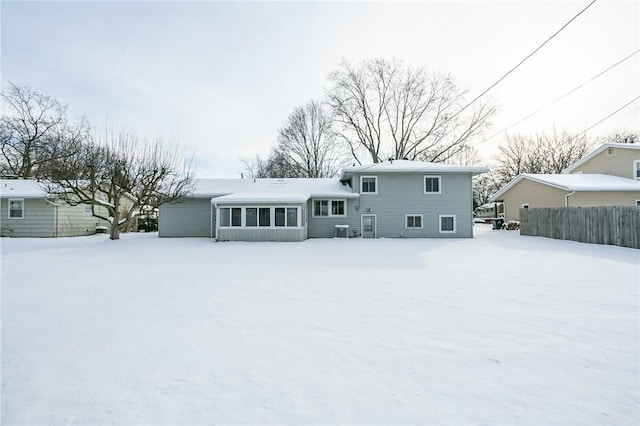 snow covered property with central AC