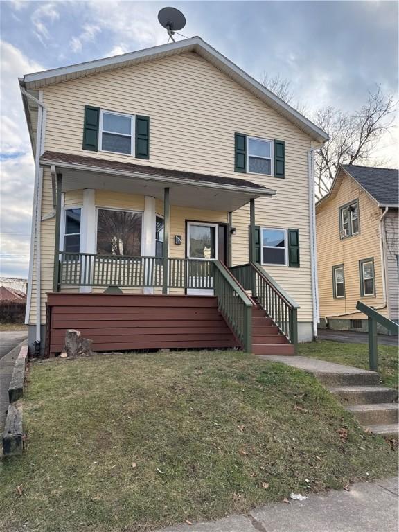 view of front of house with a front lawn and a porch