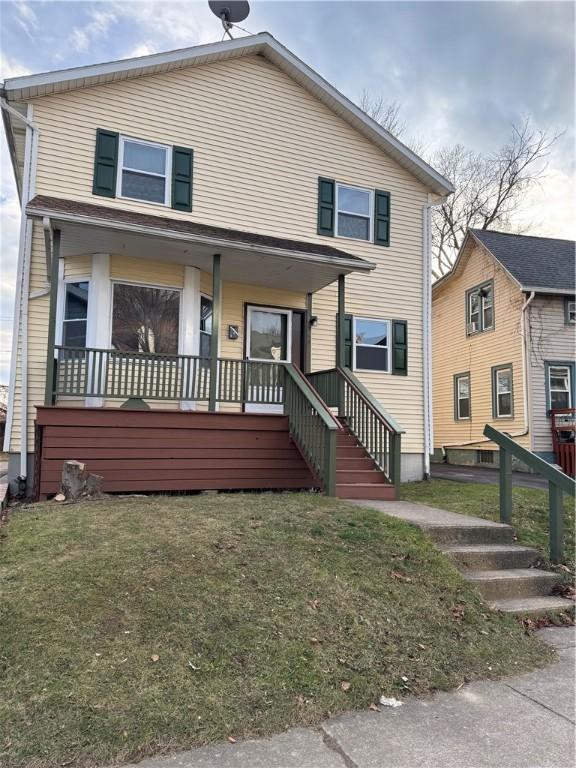 view of front facade with covered porch and a front lawn