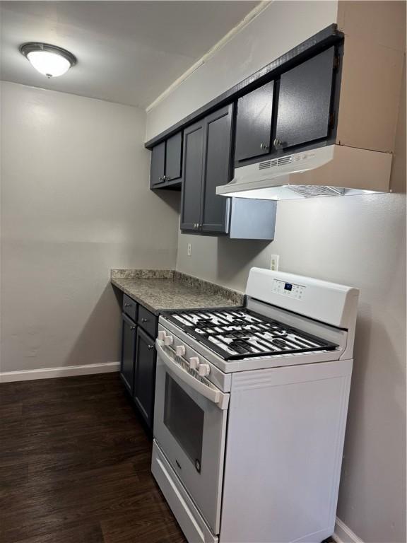 kitchen featuring dark wood-type flooring and white gas stove