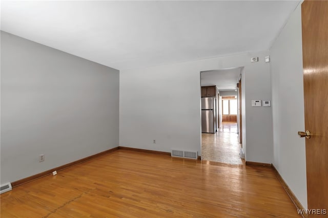 unfurnished room with light wood-type flooring