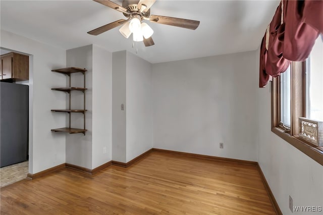 spare room featuring ceiling fan and light hardwood / wood-style flooring