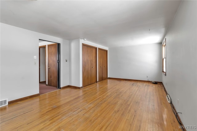 empty room with hardwood / wood-style floors