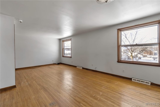 spare room with light hardwood / wood-style floors