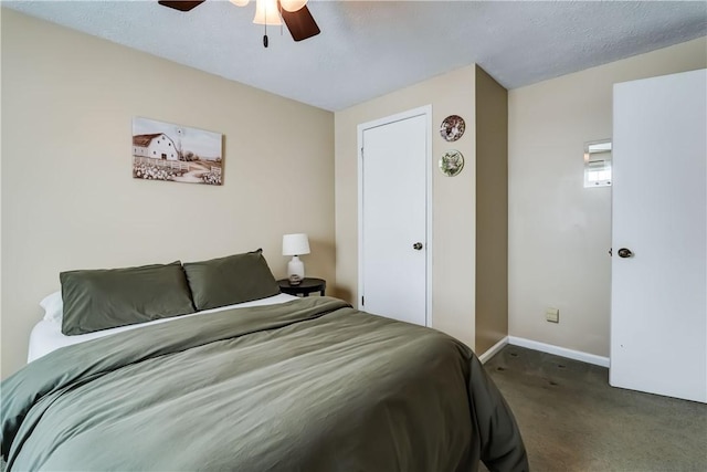 bedroom featuring ceiling fan, dark carpet, and a textured ceiling