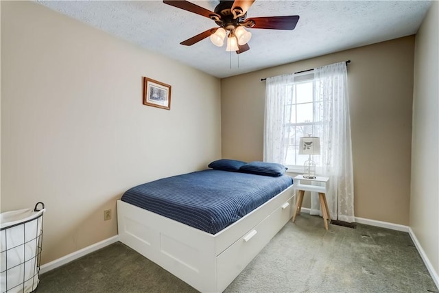 bedroom with ceiling fan, carpet, and a textured ceiling