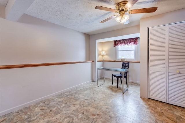 home office with ceiling fan and a textured ceiling