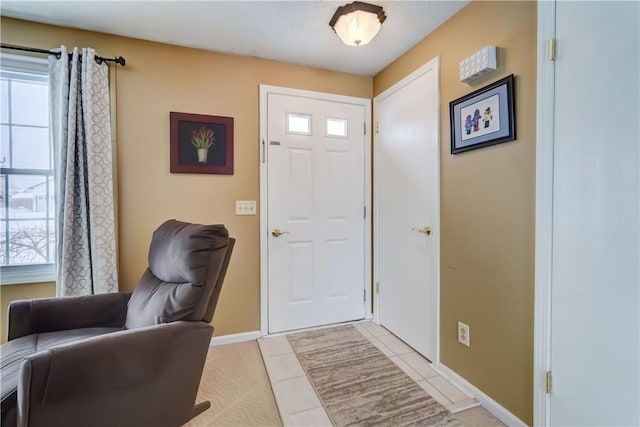 entryway with light tile patterned floors and plenty of natural light