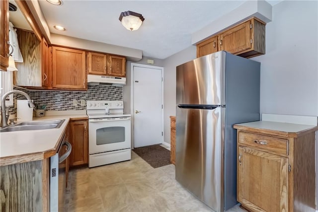 kitchen featuring decorative backsplash, sink, and appliances with stainless steel finishes