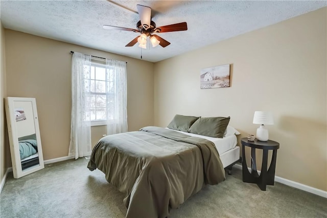 carpeted bedroom featuring a textured ceiling and ceiling fan