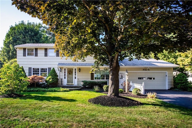 view of front of property with a garage and a front lawn