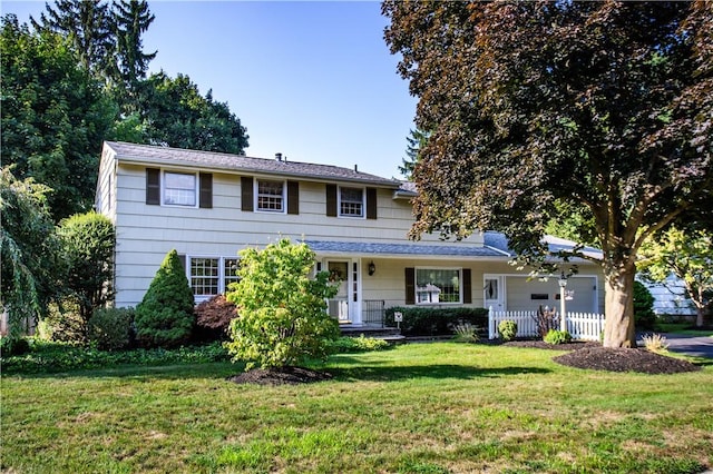 view of front of property with a front yard and a garage