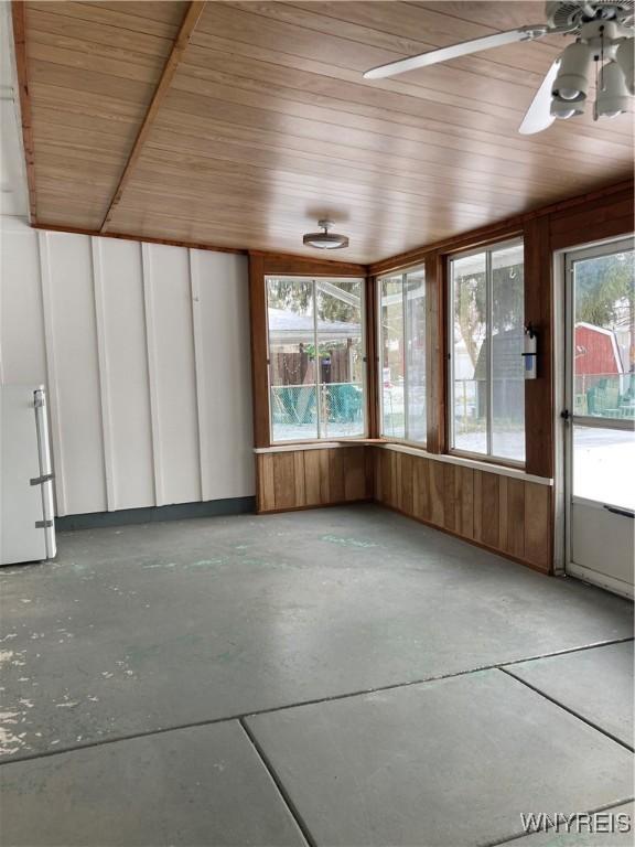 unfurnished sunroom with wood ceiling