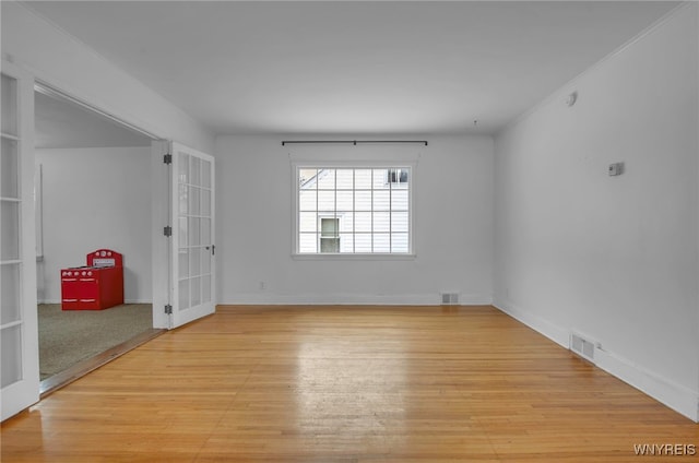 unfurnished room with light hardwood / wood-style flooring and french doors