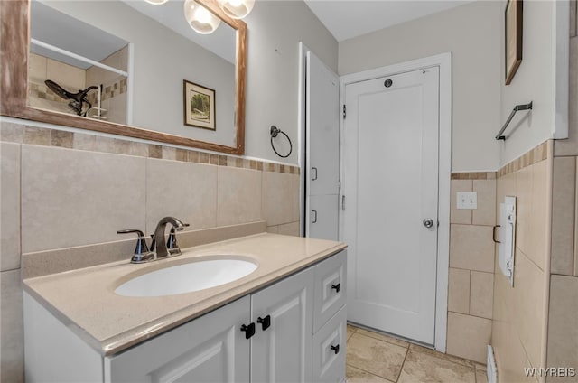 bathroom featuring tile walls, vanity, and tile patterned flooring