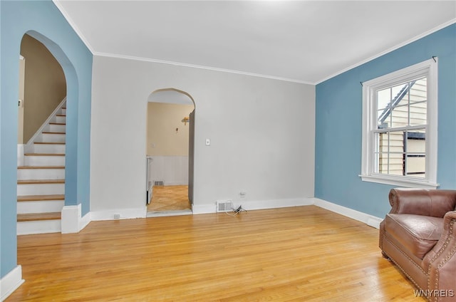 living room featuring light wood-type flooring and crown molding