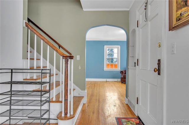 entrance foyer featuring light wood-type flooring and crown molding