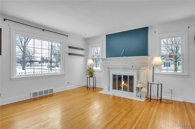 unfurnished living room with a fireplace and hardwood / wood-style flooring