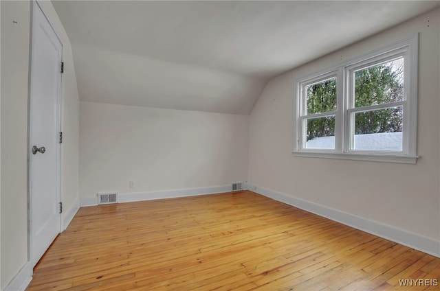 bonus room featuring lofted ceiling and light hardwood / wood-style floors