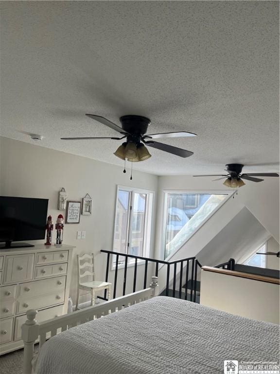 unfurnished bedroom featuring ceiling fan and a textured ceiling