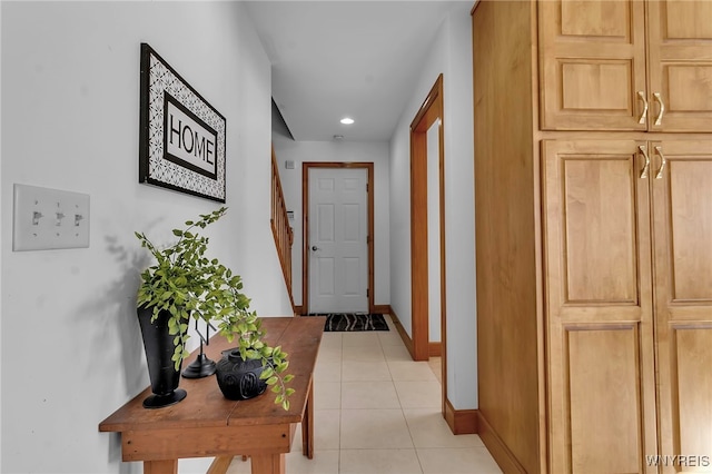 hall with light tile patterned floors