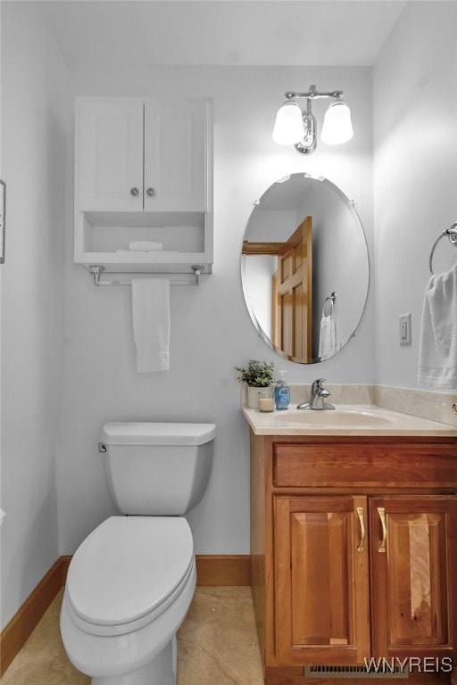 bathroom featuring toilet, tile patterned flooring, and vanity