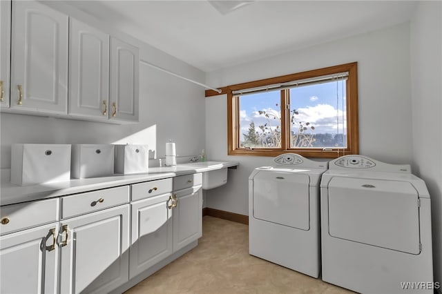 laundry area featuring washing machine and dryer and cabinets