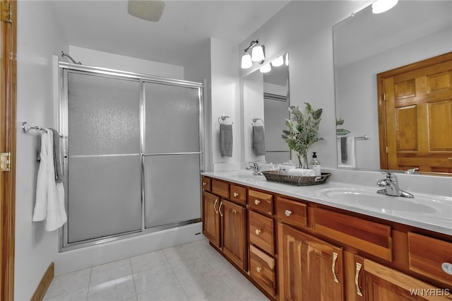 bathroom featuring an enclosed shower, vanity, and tile patterned floors