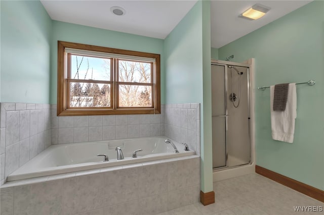 bathroom with separate shower and tub and tile patterned flooring