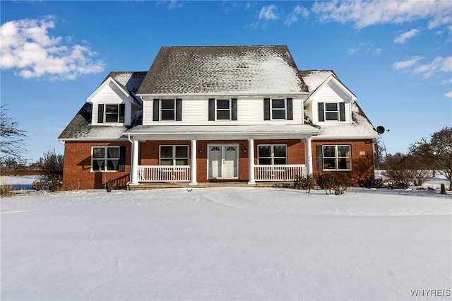 view of front facade with covered porch and brick siding