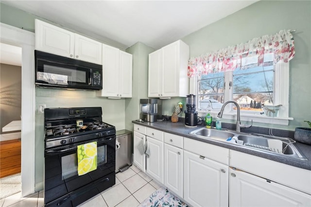 kitchen featuring light tile patterned floors, sink, white cabinets, and black appliances