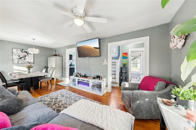 living room with ceiling fan and hardwood / wood-style flooring