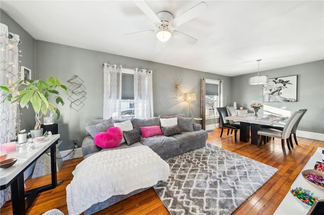 living room featuring ceiling fan and hardwood / wood-style flooring