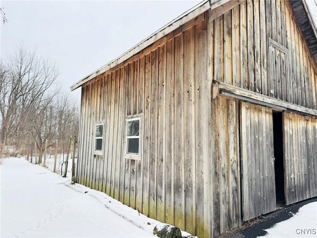 view of snow covered exterior with an outbuilding