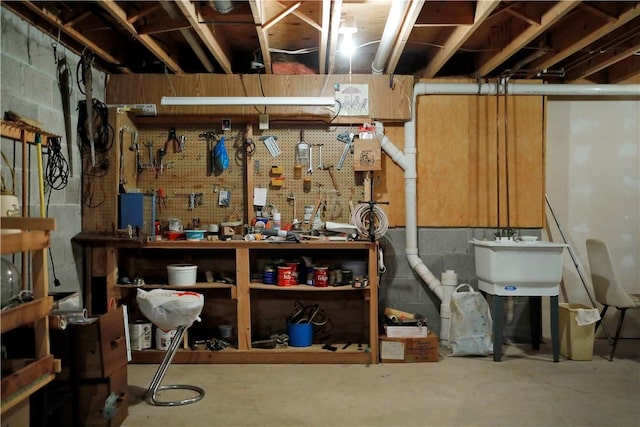 basement with sink and a workshop area