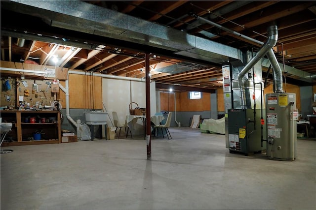 basement featuring heating unit and water heater