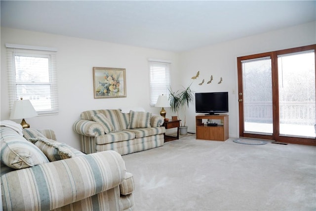 living room with a wealth of natural light and carpet