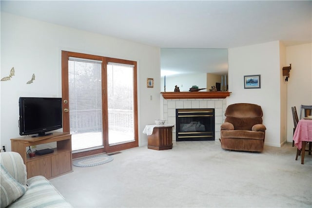 carpeted living room featuring a fireplace