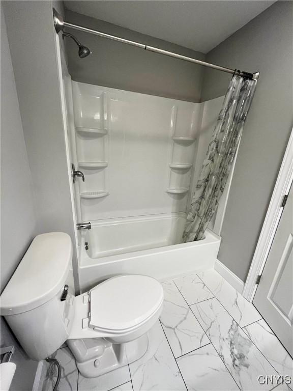 bathroom with toilet and shower / bath combo