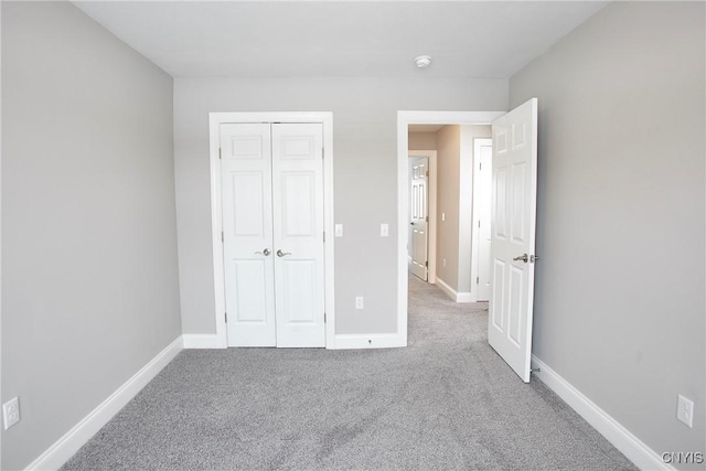 unfurnished bedroom with a closet and carpet