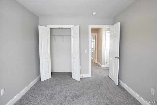 unfurnished bedroom featuring carpet floors and a closet