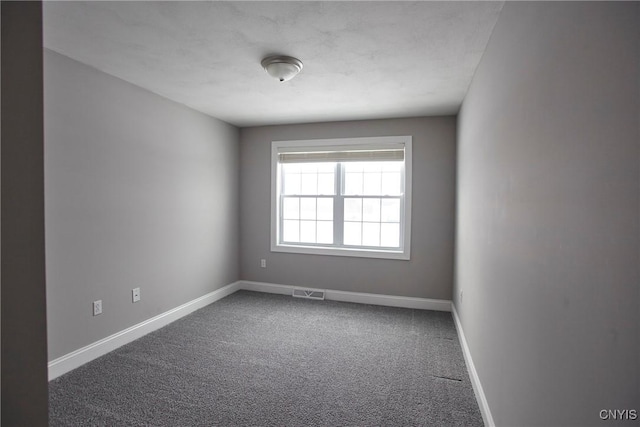 unfurnished room featuring carpet