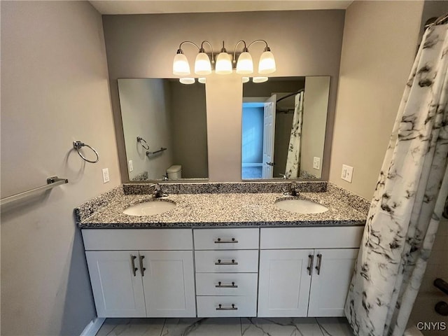 bathroom featuring toilet, vanity, and a shower with shower curtain