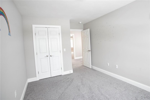 unfurnished bedroom featuring a closet and carpet