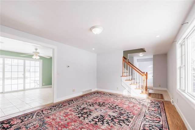 unfurnished room featuring ceiling fan and light wood-type flooring