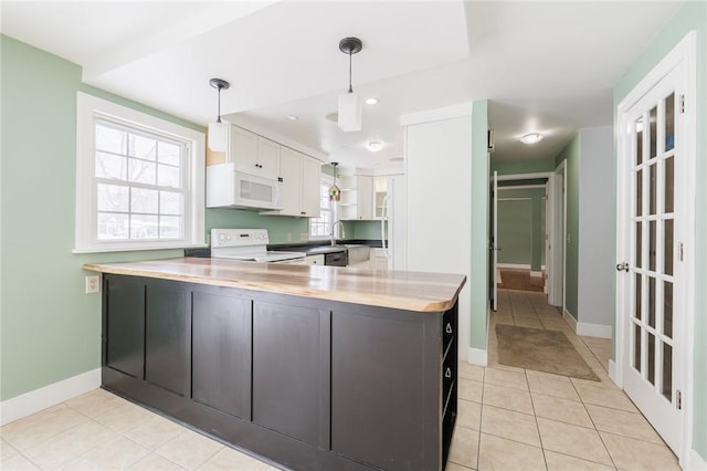 kitchen with white appliances, white cabinets, kitchen peninsula, and hanging light fixtures