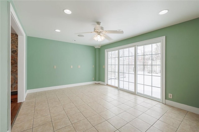 empty room with ceiling fan and light tile patterned floors