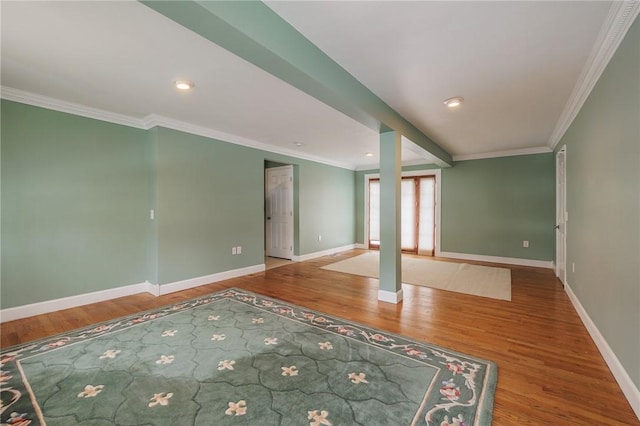 spare room with wood-type flooring and crown molding