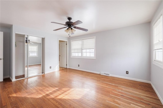 unfurnished bedroom with ceiling fan, a closet, and light hardwood / wood-style flooring